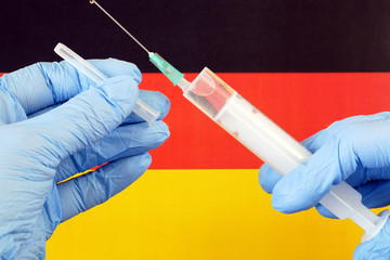 covid - 19, coronavirus concept. Surgical protective mask on Germany flag, coronavirus epidemic in...