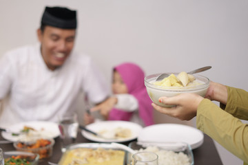 muslim man breakfasting dinner with his daugther and family at home