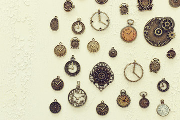 Image of old antique clocks over wooden background. Top view, flat lay