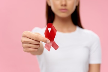 young woman holding a red heart