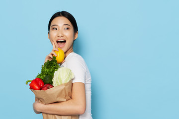 young woman holding vegetables