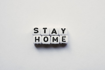 Warning Stay Home written with word cubes, Stop Corona Virus, Mock up with no people and space for Text
