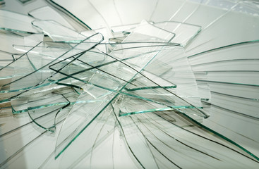Pieces of broken glass on a white surface