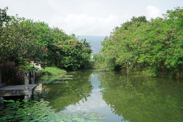 Fototapeta na wymiar Natural lake view with green mountain park and cloudy sky