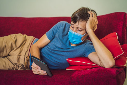E-book and online education. A man is reading a quarantined book at home. A man in a medical mask remained at home in self-isolation