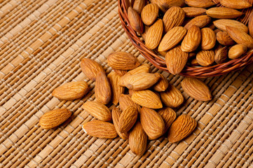 Almonds nuts shot large on a wooden background. Background for healthy eating and vegetarianism.