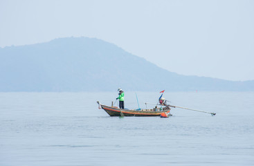 Fishermen netting fish on a boat at sea at Koh Talu , Prachuap Khiri Khan in Thailand. 