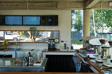 Interior design and decoration of  local coffee bar and bakery shop decorated with white furniture and espresso machine