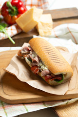 Sandwich panini version, long baked beef meat, pulled in fresh baquette with fresh salad and hot sause