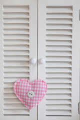 Fabric Heart Hanging From Cabinet