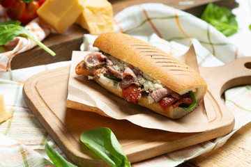 Sandwich panini version, long baked beef meat, pulled in fresh baquette with fresh salad and hot sause