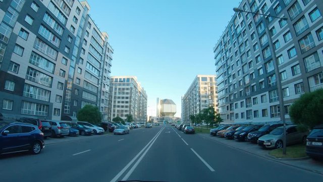 Residential area, first-person view of a moving car on empty street, quarantine in the city, empty roads and streets.