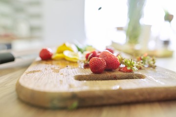 Making drink, close-up on cutting board strawberries mint lemon, knife