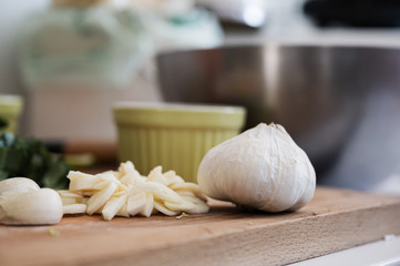 Low angle view of a chopped garlic next to a whole garlic head