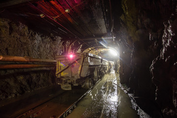 Underground chrome mine tunnel with wagons ore carts