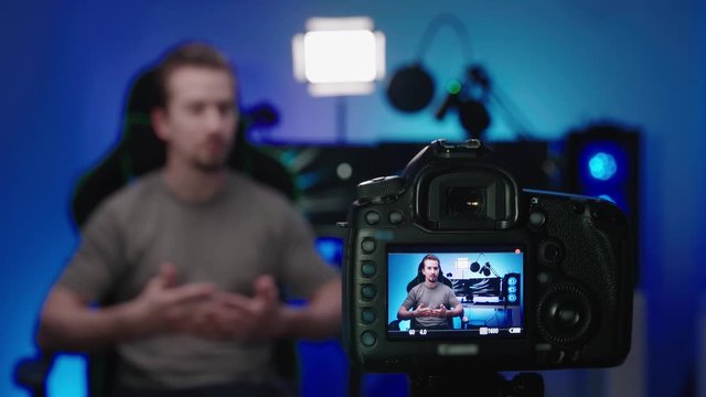 Tech influencer shooting video with photo camera 4K