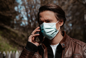 Corona - Covid-19 conceptual image - rear view of a man wearing a face mask