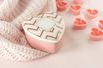 Heart shaped candles on the soft pink background