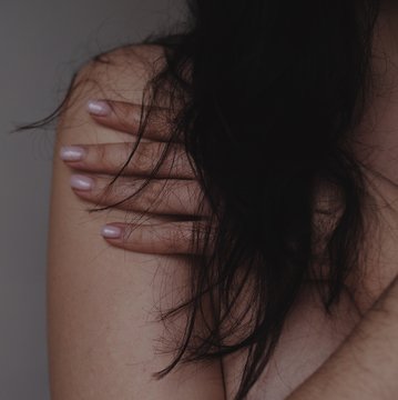 woman cheast with hair and hand