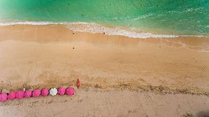 Top view of a Pandawa beach with many umbrellas and people relaxing. Bali, Indonesia.