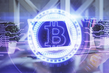 Multi exposure of blockchain and crypto economy theme hologram and table with computer background. Concept of bitcoin cryptocurrency.