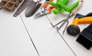 A lot of different garden equipment on the wooden table
