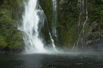 Waterfall in Milford Sound in Fiordland National Park in Southland on South Island of New Zealand
