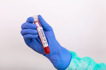 Coronavirus Covid 19 infected blood sample in sample tube in hand of scientist doctor biohazard protection clothing in coronavirus covid 19 research laboratory, Coronavirus Covid-19 vaccine research