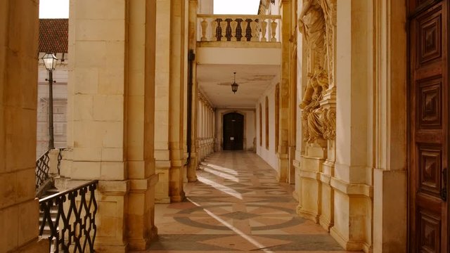 POV walk along the colonnade of the Faculty od Law, University of Coimbra, Portugal, one of the oldest in the world, dating to 1290