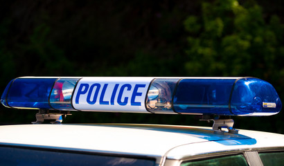 Fototapeta premium View of POLICE sign with lights, atop an emergency response patrol vehicle.