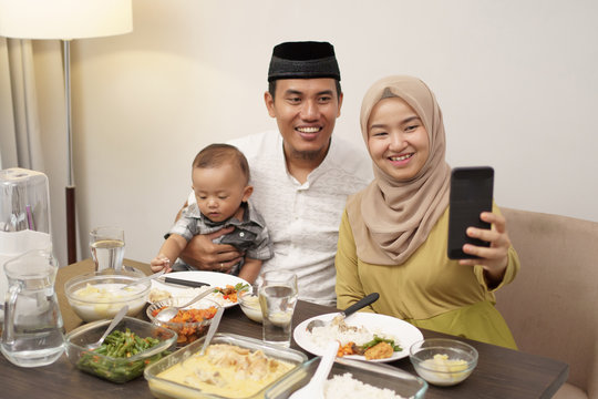 muslim family make video phone call while dinner at home