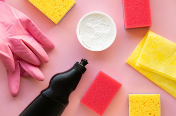 Cleaning products and items on a pink background