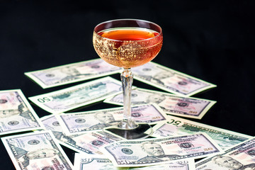 Cocktail on a dark background with money and decor