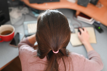 Fototapeta premium girl works behind computer monitors. background. remote work. freelance. work at home