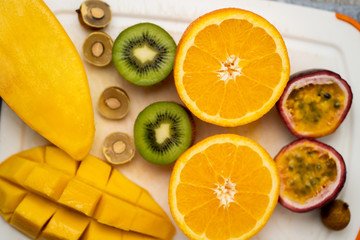 Exotic fruits on white cutting board