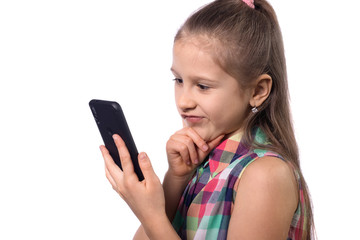 Fototapeta premium Cute little girl using mobile phone on white background.