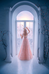 Sad princess looking window staying home. Queen lady enjoy evening sunset. concept freedom. long...