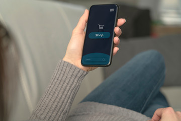 Woman use the smartphone for shopping online on the sofa at home