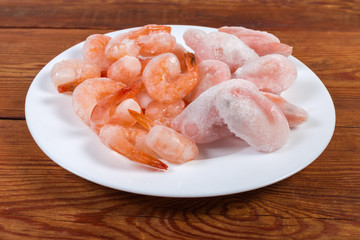 Prawn tails and usual shrimps in ice glazing close-up