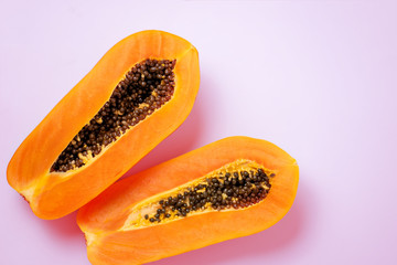 Ripe papaya on pink background