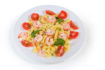 Cooked farfalle pasta with shrimp tails and cherry tomatoes