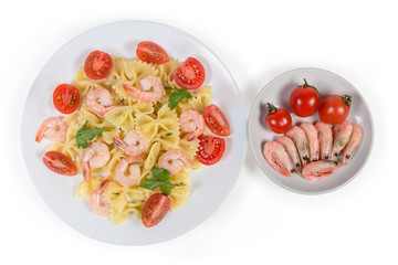 Farfalle pasta with shrimp and tomatoes, ingredients, top view