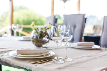 Wedding decor, wine glasses and champagne flutes on table. Selective focus