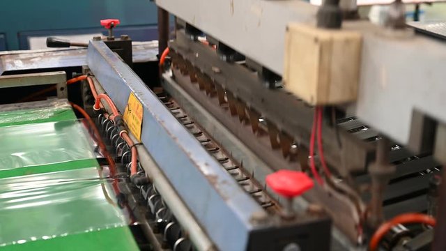 The operation of the side seal opp plastic bag cutting machine Closeup at the seal and cutting knife set in the concept of saving the world and the environment.