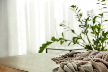 Table background of free space and blurred home interior and window sill 