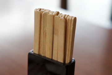 Wooden stir sticks on table,  coffee shop