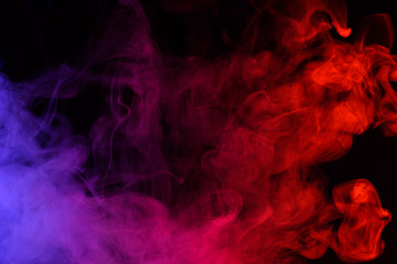 Colored smoke clouds flowing dark abstract background