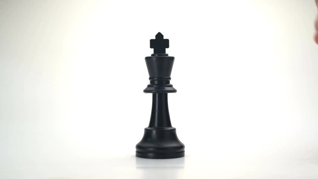 Video 4k - hand holding or moving white king chess to Defeat Crash Attack or Kill black king on white Background. Chess VDO for Business concept- Challenge Competition Leader Power Success Win or lose