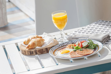 breakfast of fried eggs, croissants