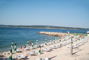 beach lounging on the sea. beach near the town of Crikvenica. the beginning of the tourist season....